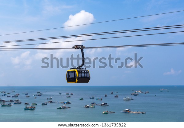 Seascape with fishing\
boats and cable car.
