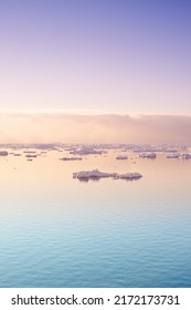 Seascape with floating glaciers at dawn. Serene winter arctic landscape. Icebergs on calm sea horizon at sunset in Denmark. Colorful nature scene of midnight sun. Polar summer in Ilulissat Greenland - Shutterstock ID 2172173731