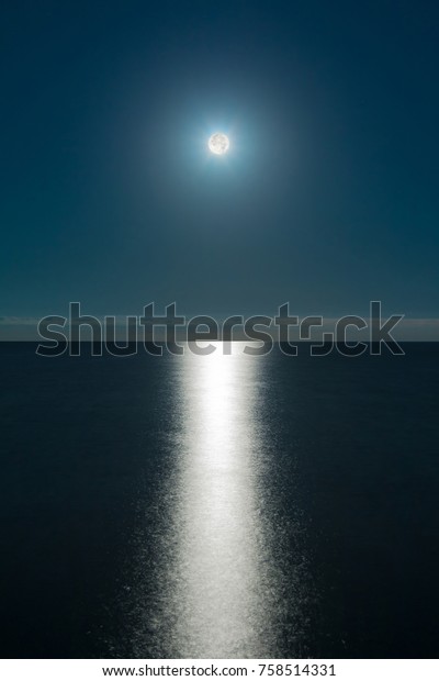 Seascape with the full moon over the sea and the\
moon glade