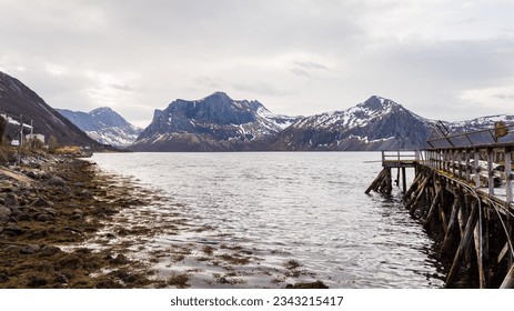 seascape inside the Island of Senja in the area of Skaland with snowcapped mountain in the background, Norway - Powered by Shutterstock