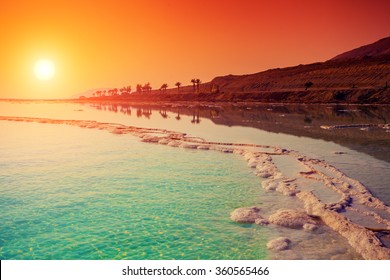 Seascape in the morning. Orange sunrise over Dead Sea. 