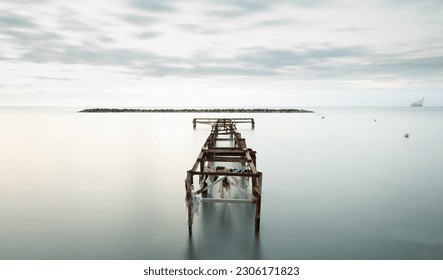 Seascape with old deserted industrial jetty at sunset. Abandoned damaged pier in the ocean. Long exposure Cyprus - Powered by Shutterstock