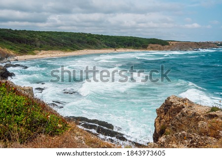 Seascape on a picturesque coast,  bay with sandy beach and sea with big foam waves, Bulgarian coastline near the village of Sinemorets, Bulgaria, Europe.