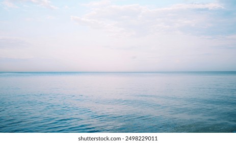 Seascape. Purple minimalist landscape. Calm sea. Horizon. Clear horizon. Clouds in the sky. Sunset. Pink colors - Powered by Shutterstock