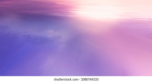 Seascape with the rising sun and pink and purple clouds reflected on the water.