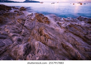 Seascape of rocks in long exposure,Waves crashing on seashore in Sunset or sunrise over sea surface nature for background - Powered by Shutterstock