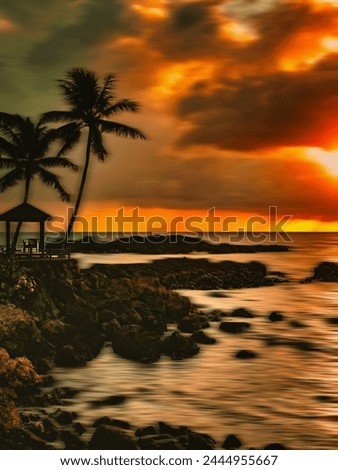Seascape sunset with dramatic sky and long exposure in Hawaii