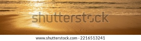 Seascape at sunset. Golden sunset over the sea. Beautiful beach in the evening. Horizontal banner