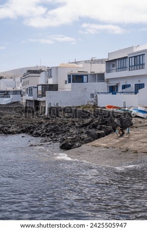 Seascape. Typical white classics with blue windows. Wharf of the village of Arrieta. Turquoise Atlantic Ocean. Village of Arrieta. Lanzarote, Canary Islands, Spain