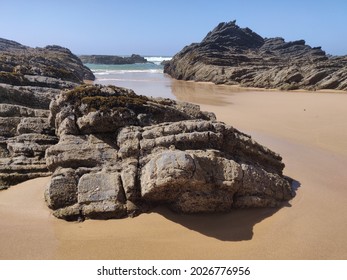 Seascape of Vale dos Homens beach at low tide.