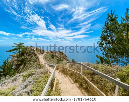 Seascape. The walkway leads to the observation deck. Summer, sunny day. Blue sky with white clouds. Muir woods beach overlook, California, USA