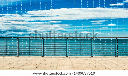 Similar – wooden platform with blue posts with ropes and orange lifebuoys on the background of the sea and sky with clouds Egypt Dahab South Sinai