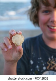 Seashell Held by a Young Boy on the Beach