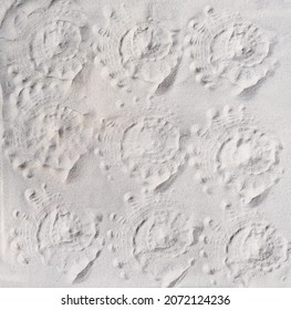 seashell prints on a sand, top view. pattern of imprints of seashells on a beach. summer vacation and travel concept - Shutterstock ID 2072124236