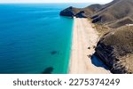 Seashore, coastline, scenic view of people at unspoiled beach in Almeria, called Playa de los Muertos, in English The beach of Deads due to the strong currents that cause many deaths year after year