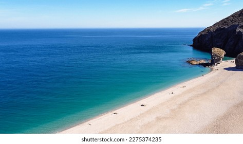 Seashore, coastline, scenic view of people at unspoiled beach in Almeria, called Playa de los Muertos, in English The beach of Deads due to the strong currents that cause many deaths year after year - Shutterstock ID 2275374235