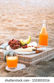 Seaside Beach Picnic On Sand Concept, Bamboo Table With Cheese Platter, Dark Red Grapes And Watermelon, Crackers, Orange Juice, Copy Space, Relaxed Resort Eating, Beautiful Lifestyle Concept 