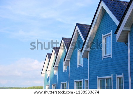 Seaside cottage. New house for rent. Row of beach rentals. Blue seaside house.