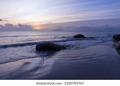Seaside landscape with wet sand and coastal stones at sunset. Beau Vallon Beach, Seychelles - Shutterstock ID 2350703767