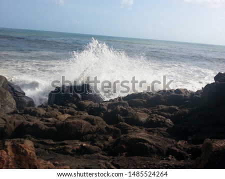 seaside rocks . Waves hitting. Bright sea