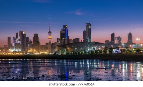 Seaside skyline of Kuwait city from night to day transition timelapse. Modern illuminated towers and skyscrapers reflected in water.