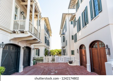 Seaside, USA - April 25, 2018: Wooden houses community parking garage townhomes, townhouses, by beach ocean, nobody on vacation in Florida view during sunny day