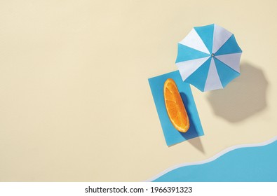 Seaside Vacation Concept - Aerial View Of The Beach With Umbrella And Orange - Minimal Summer Photo - Vacation Concept