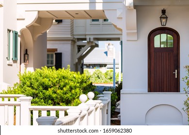 Seaside white beach wooden wood architecture door and path way with green landscaping shrubs bushes on sunny day - Powered by Shutterstock