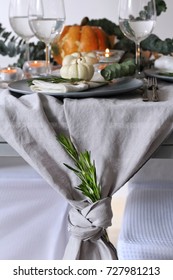 Seasonal Autumn Table Decoration With Pumpkin, Rosemary, Leaves And Candles