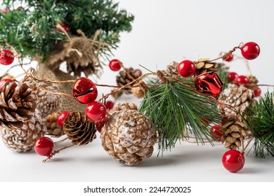 seasonal christmas  and New Year traditional decoration of red berry balls, bells and pine cones with artificial snow - Powered by Shutterstock