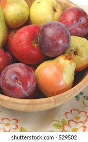 A Seasonal Holiday Fruit Bowl With Bartlett Pears, Paula Red Apples And Red Plums