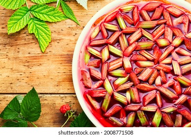 Seasonal pie or cake with rhubarb stalks and raspberries. Summer sweet dessert.Rhubarb tart
