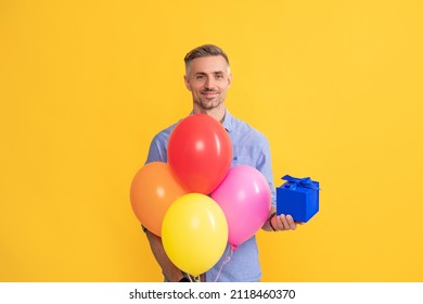 seasonal sales. man with box and balloons. boxing day. present and gifts buy.