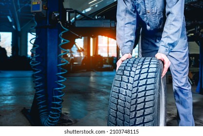 Seasonal Tire Changeover In Auto Service. Tire Swap Background With Copy Space. Winter Tire Storage.