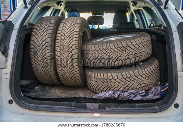 seasonal\
wheel change, spare tires in the trunk of a\
car