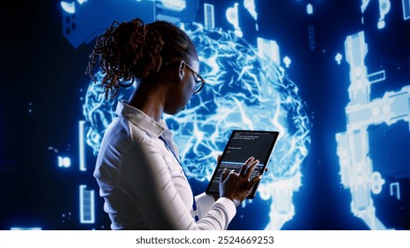 Seasoned IT contractor programming scripts on tablet, employing AI machine learning. Proficient worker manipulating lines of code for artificial intelligence applications development