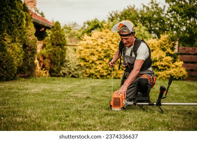 A seasoned gardener, this senior man gears up to trim the grass in his backyard - Powered by Shutterstock