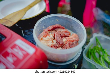 Seasoned Marinated Pork In A Clear Plastic Bowl, Camping Menu.