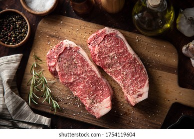 seasoned raw sirloin beef steak on cutting board - Powered by Shutterstock