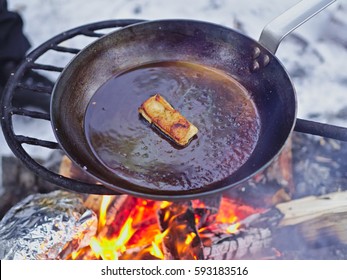 Seasoning Carbon Steel Pan With Lard On Open Camp Fire.