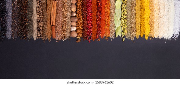 Seasoning, spice and herbs on black background with copy space. Panorami? background with various condiments for food, top view - Shutterstock ID 1588961602