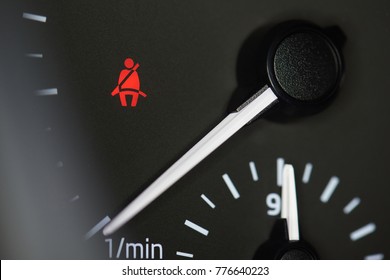 Seat belt icon on car dashboard macro close up
