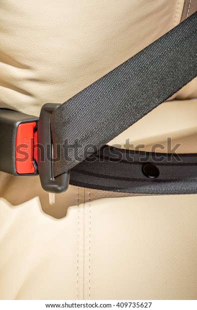 seat belt on a beige leather\
seat