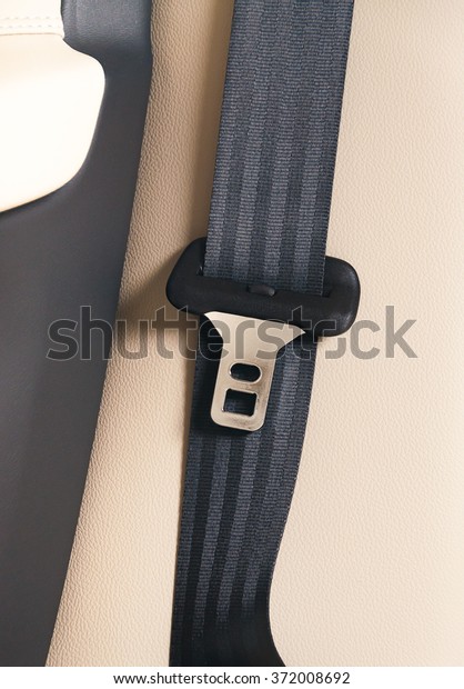 seat belt on a white\
leather chair