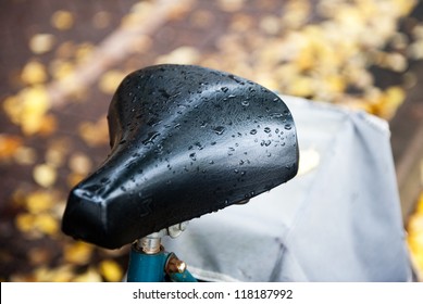 The seat of a bicycle with raindrops