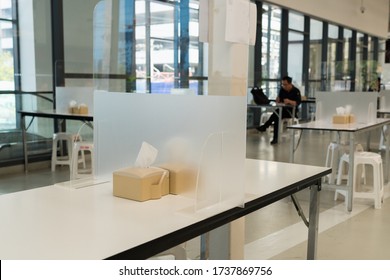Seat for customers sitting separated in food center with table shield plastic partition to protect infection from coronavirus covid-19 in Thailand, restaurant and social distancing concept