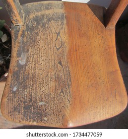 Seat Of A Half Restored Antique Elm And Beech Kitchen Chair Showing Before And After Sanding. Antique Furniture Restoration.