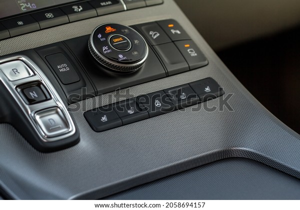 Seat heating and steering wheel heating controller\
buttons close up view. 