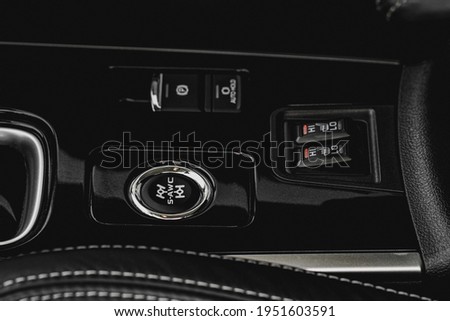 Seat heating and Super All Wheel controller buttons close up view. Car interior. Four-wheel drive button. S-AWC.