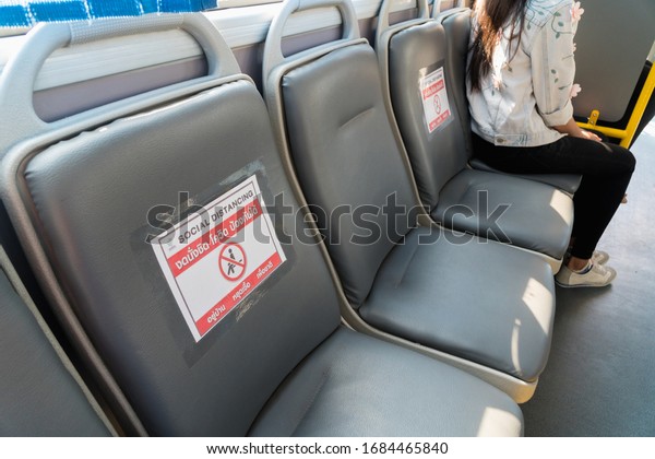 Seat on public buses with signs social\
distancing protect for pandemic of disease virus Covid-19 in\
Thailand,Thai language translation No sitting, Covid, Protect,Stay\
at home,Stop \
\
infection,national